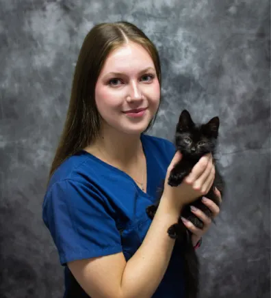 Ava holding a little black kitten